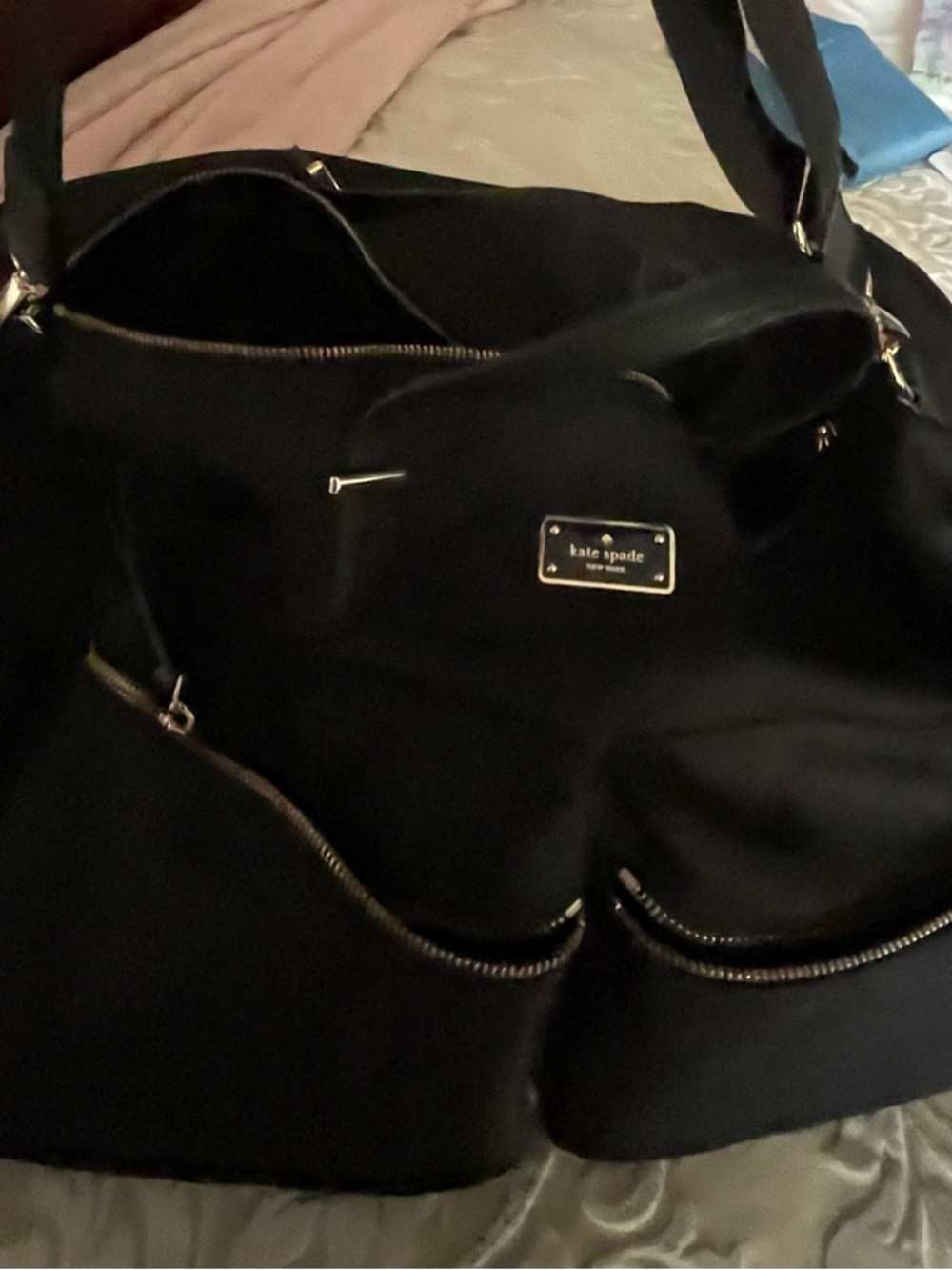 kate spade black tote with gold plaque and zipper accents